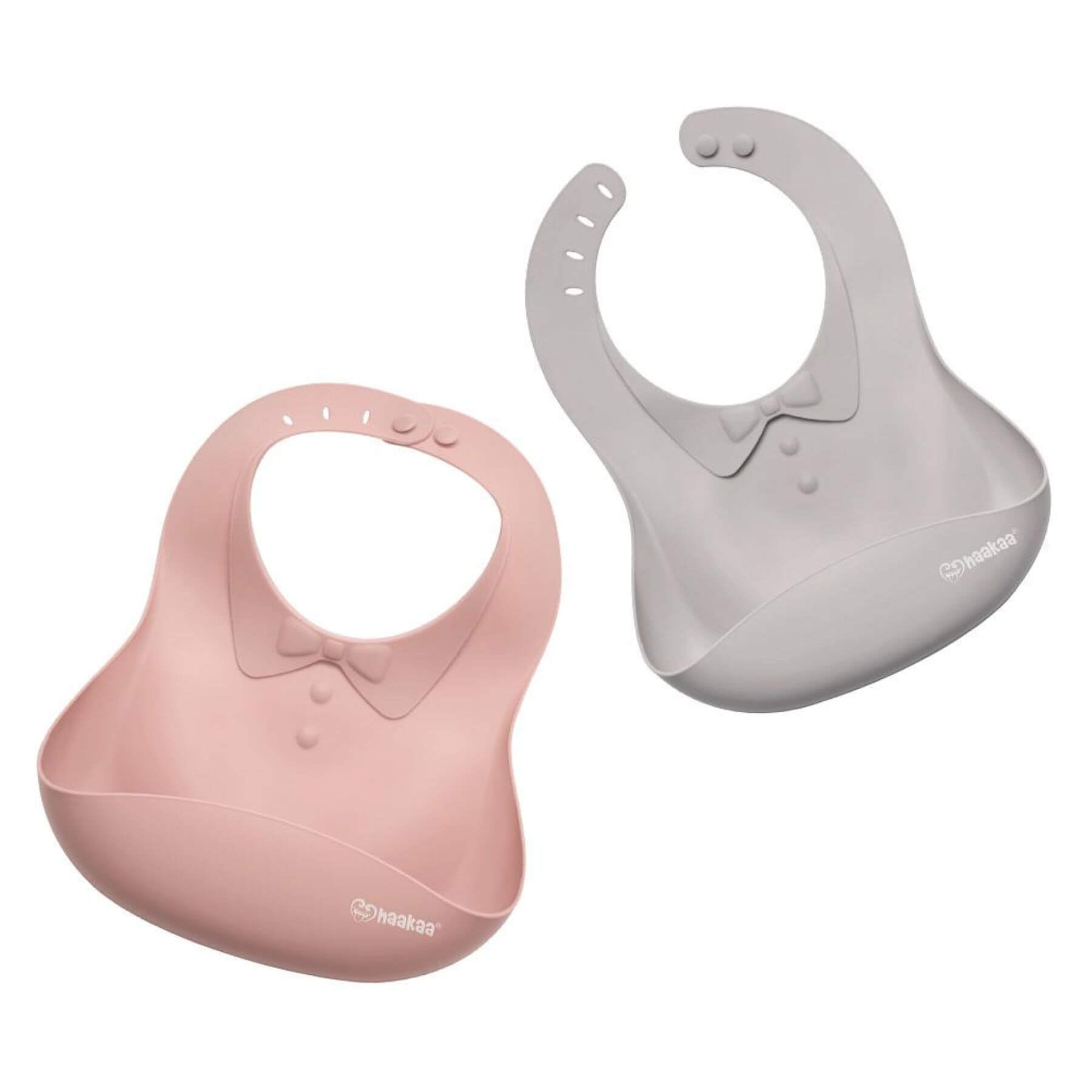Two Haakaa Silicone Baby Bibs, one pink and one gray, on a white background.