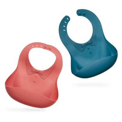 Two Haakaa Silicone Baby Bibs, one red and one blue, on a white background
