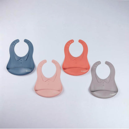 Four silicone bibs in blue, pink, and gray on a light gray background