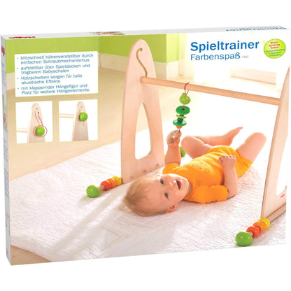 Baby play gym with colorful hanging toys on a packaging box