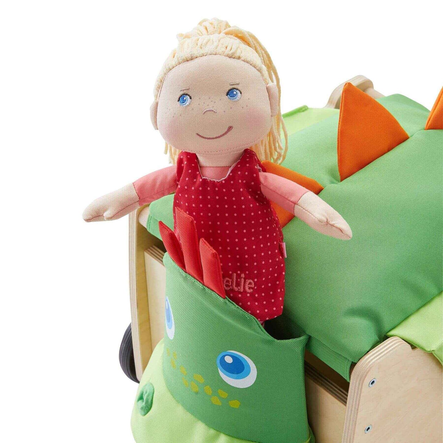 Toy doll with blonde hair and blue eyes inside a green dinosaur-shaped toy