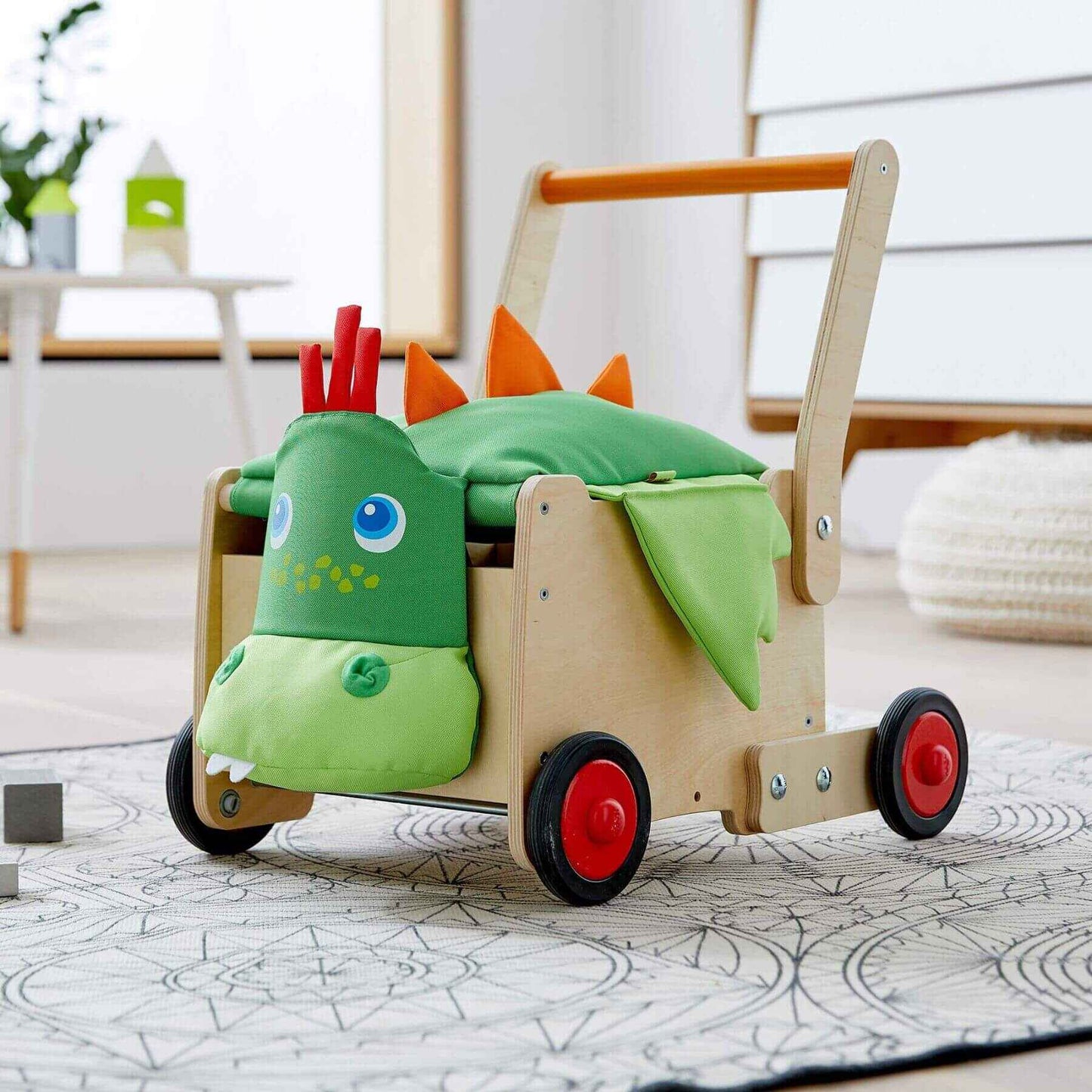 HABA USA Dragon Wagon Baby Walker on a light-colored floor.