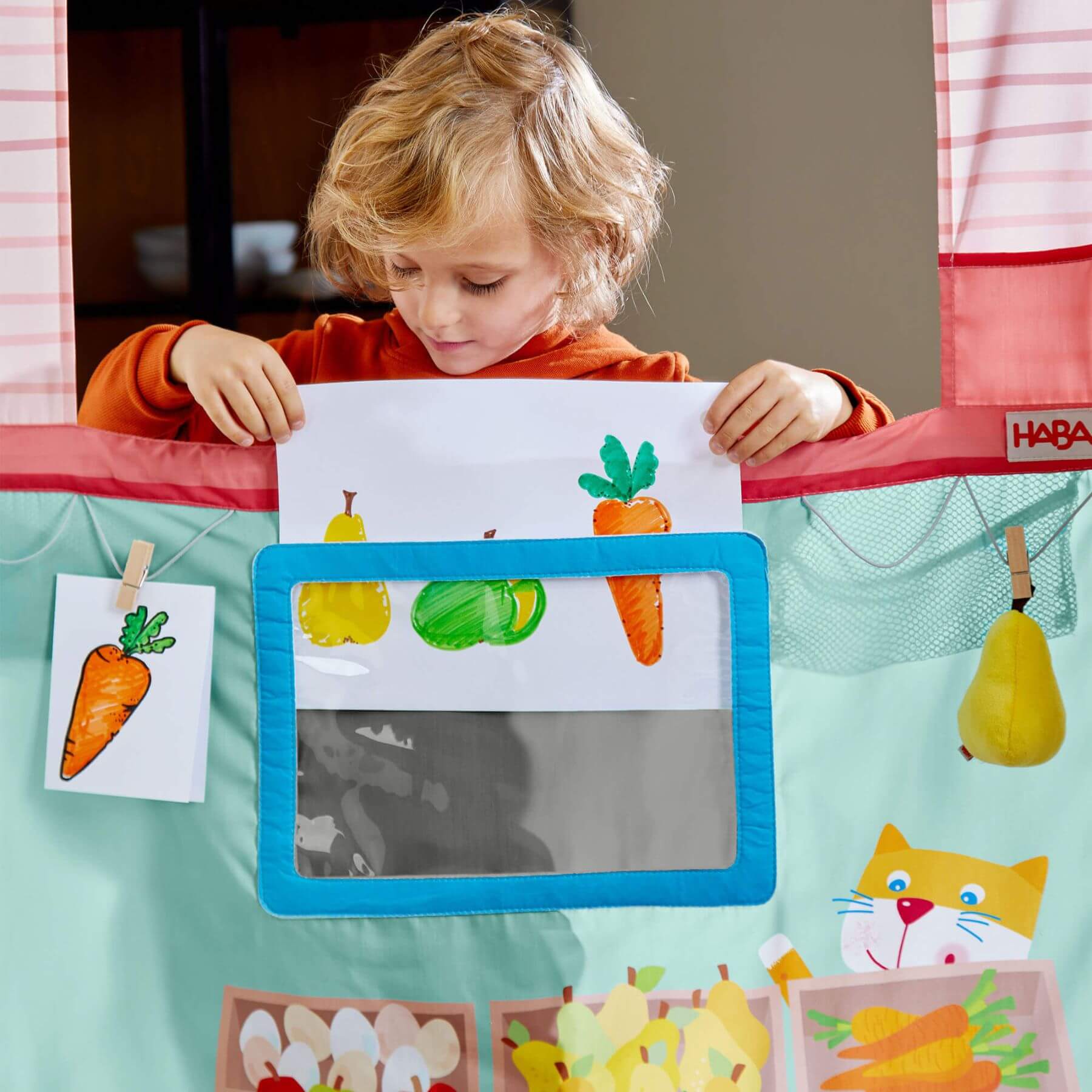 Child playing with HABA USA Hanging Doorway Play Store