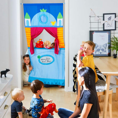 Children playing with a colorful puppet theater in a home setting.