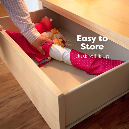 Person organizing toys in a wooden drawer with text 'Easy to Store Just roll it up'.