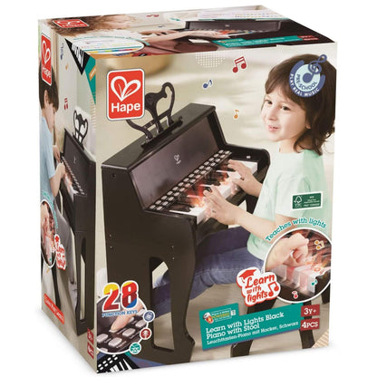Hape toy piano packaging with child playing on a white background