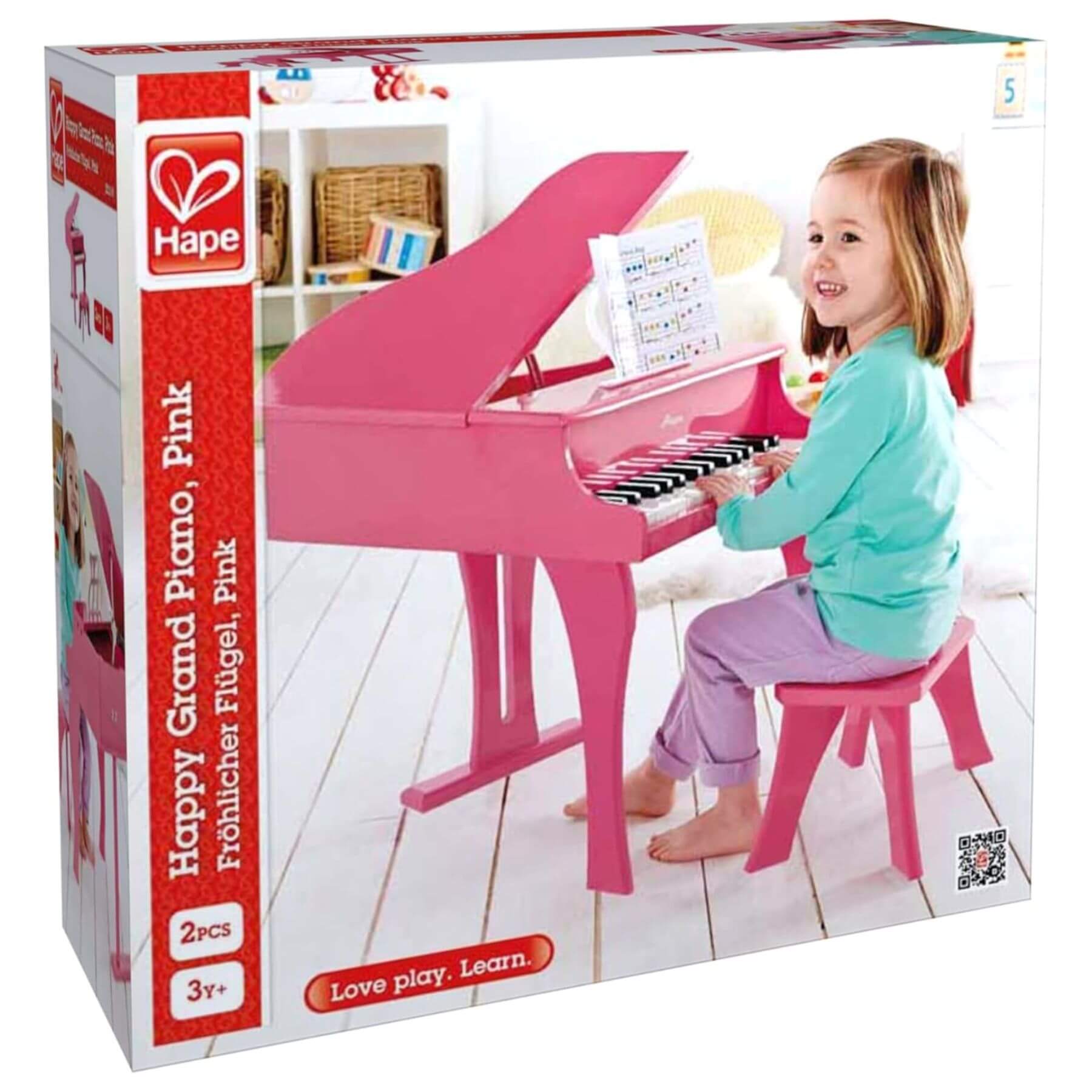 Box of Hape Happy Grand Piano Pink toy with a child playing on packaging