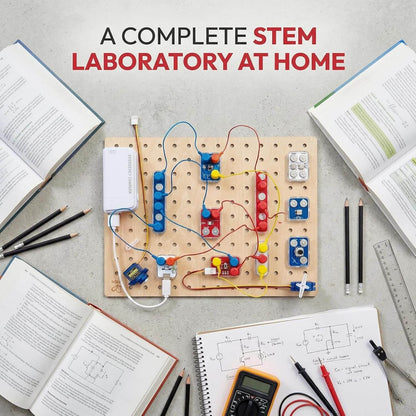 Hape Lab Box Circuit Explorer Boost on a pegboard, books, and tools on a gray surface.