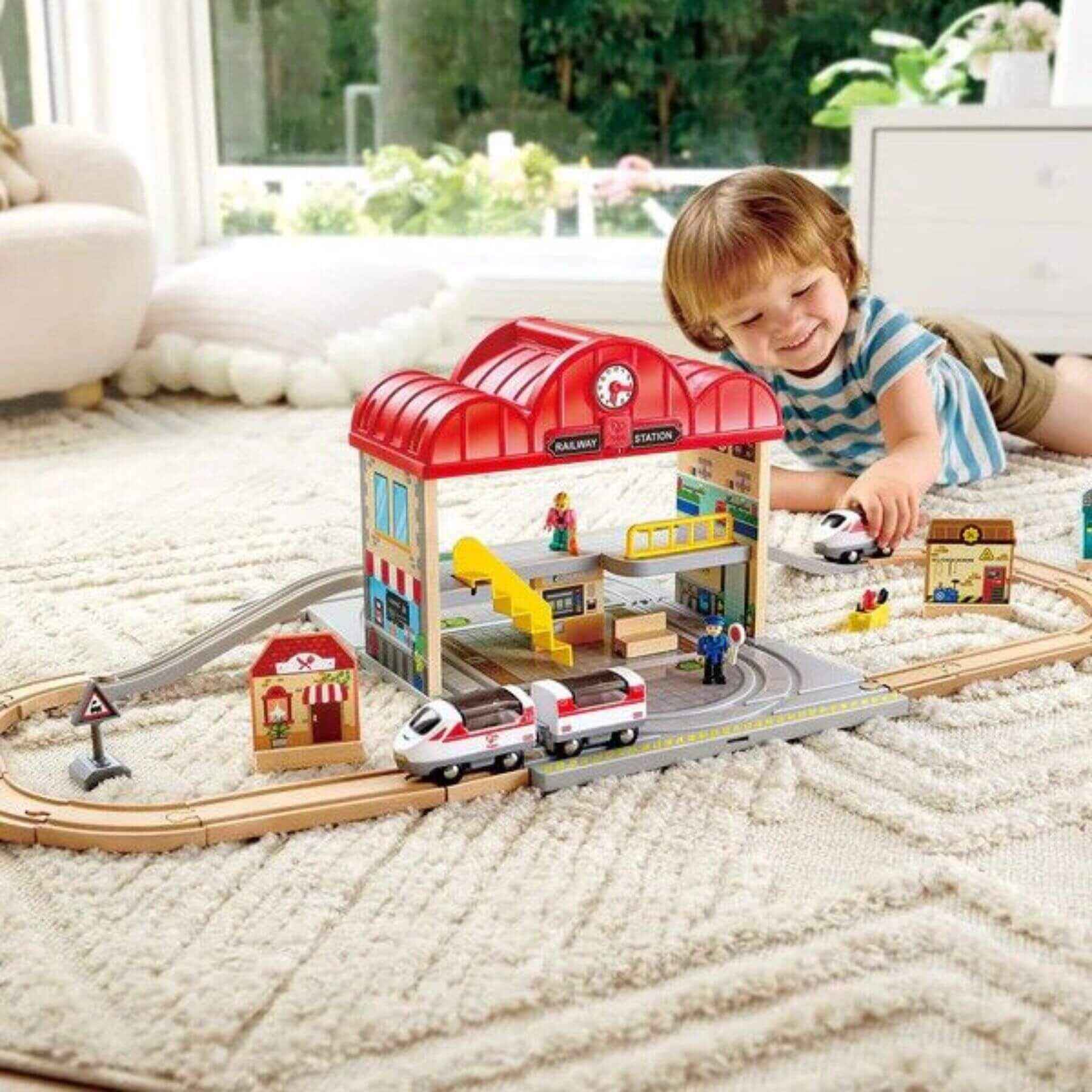 Kid Playing Hape Portable Train Station Set