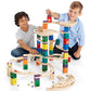 Boys Playing Hape Quadrilla Cyclone Wooden Marble Run Blocks