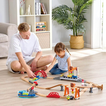 Man and girl playing with Hape Sea & Rail Cargo Transportation Set