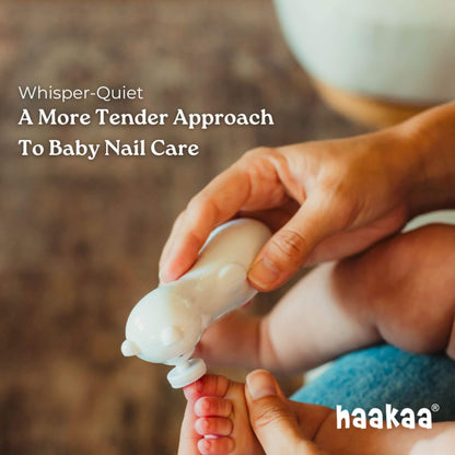 Person holding a baby's foot with a nail trimmer labeled 'naakaa' for baby nail care.