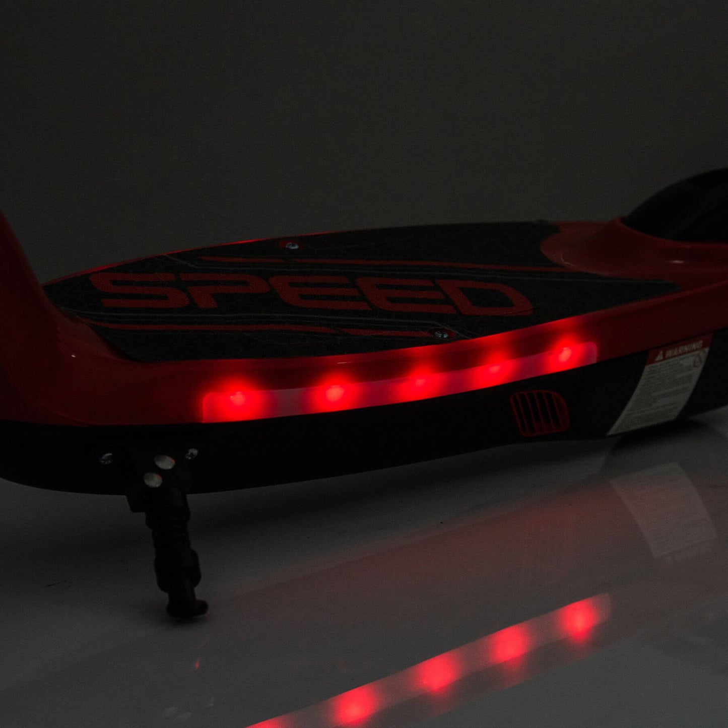 Red and black scooter with LED lights on a dark background