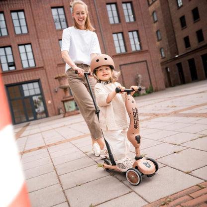 Woman and child with a scooter in an urban setting