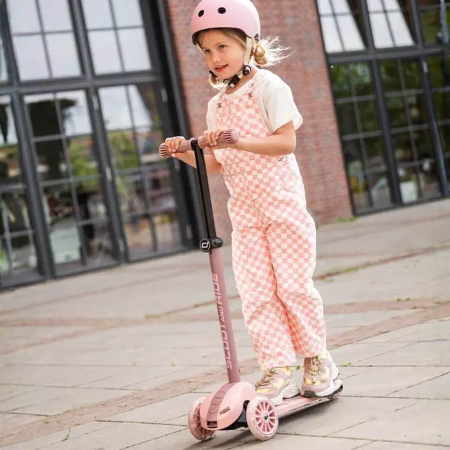 Kid riding on Highwaykick 3S Kids Scooter Rose outdoor