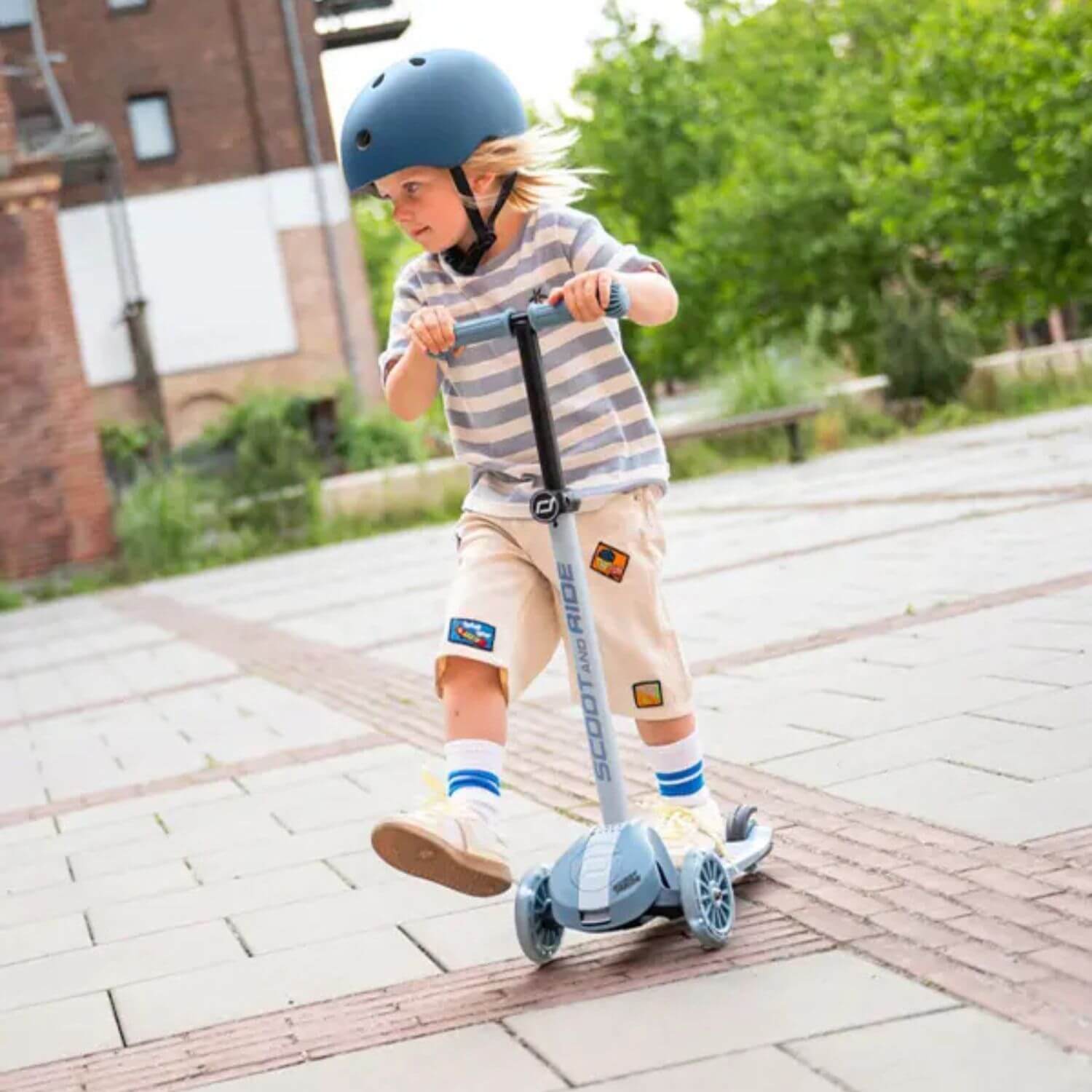 Kid riding on Highwaykick 3S Kids Scooter – Steel outdoor