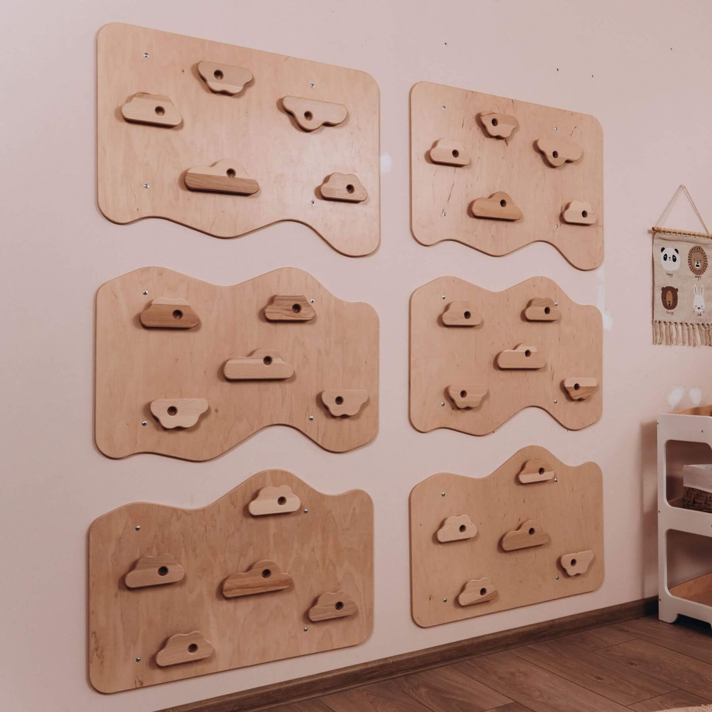 Wooden climbing wall panels on a wall in a room.