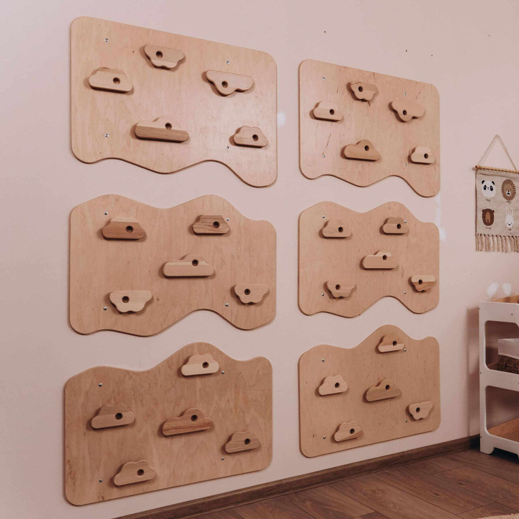 Wooden climbing wall panels on a wall in a room.