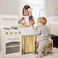 Two children playing with Tiny Land® Honey Kitchenette - Little Chef's First Kitchen in a bright room.