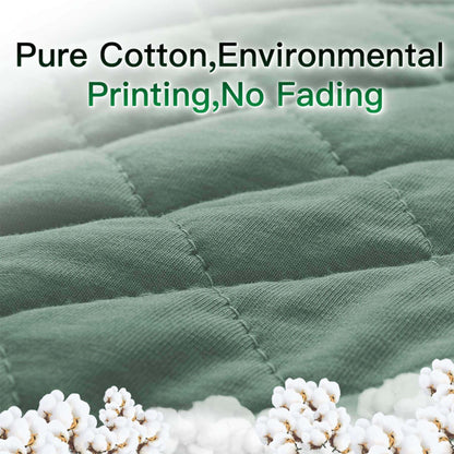 Green fabric with cotton plants and text about pure cotton, environmental printing, and no fading.