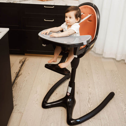 Child sitting in Hot Mom High Chair - Black Gold in a kitchen setting