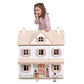 Child playing with Tender Leaf Humming Bird House with miniature figures on a white background