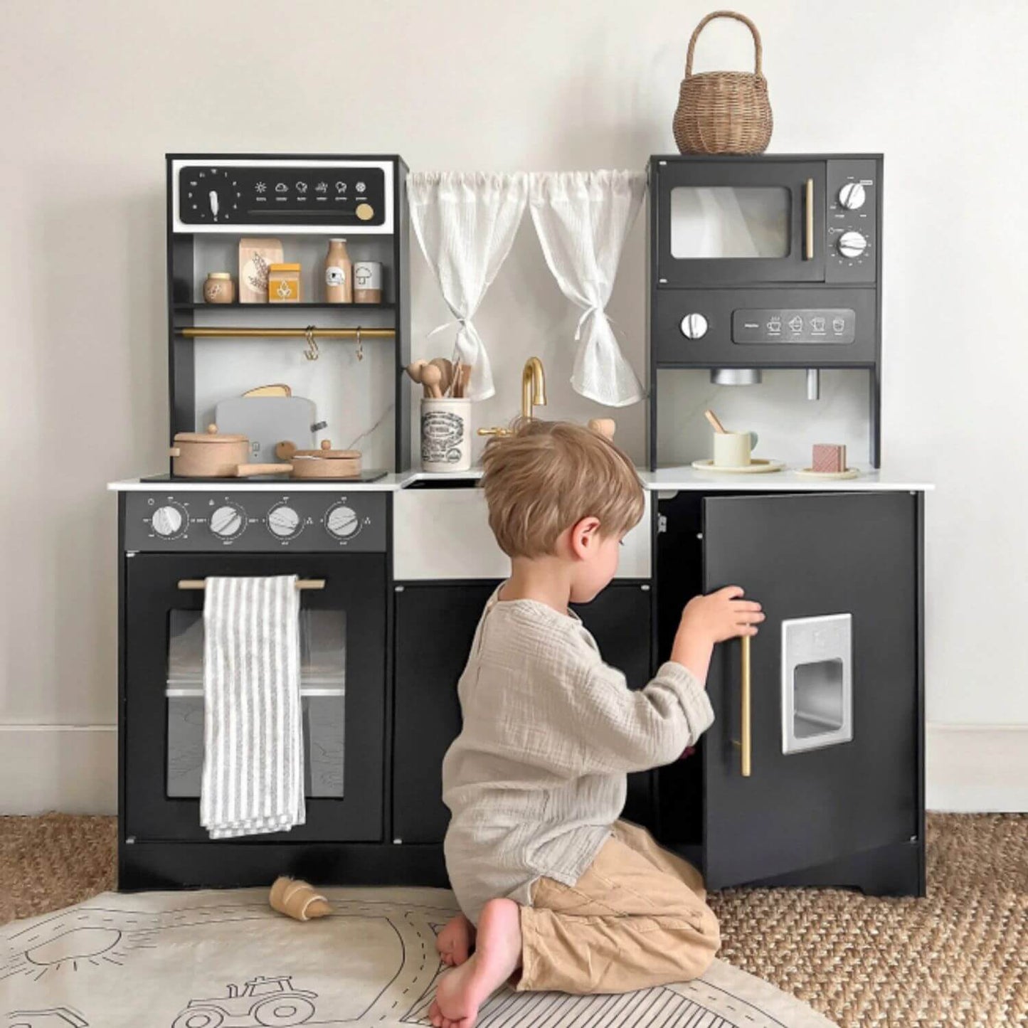 Boy Playing Tiny Land® Iconic Kitchen - Black