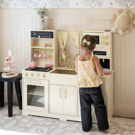 Girl Playing Tiny Land® Iconic Play Kitchen - Cream