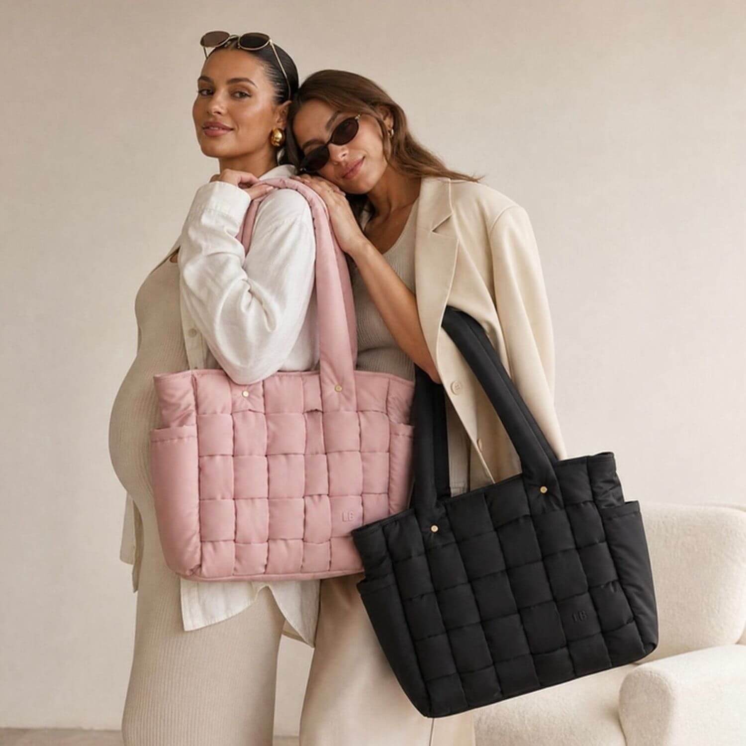 Two women posing indoors with Luli Bebé Infinite Diaper Bags