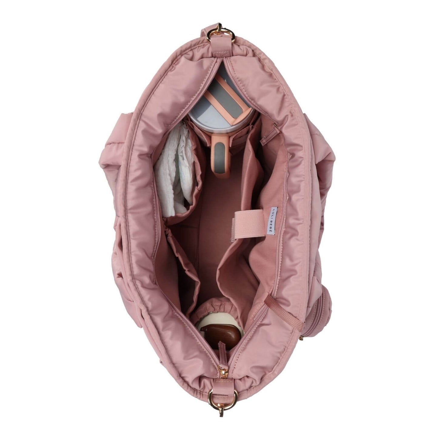 An overhead view of Luli Bebé Infinite Diaper Bag - Blush shown open to display its interior organization, including pockets, a cup holder, and storage compartments, on a solid white background.