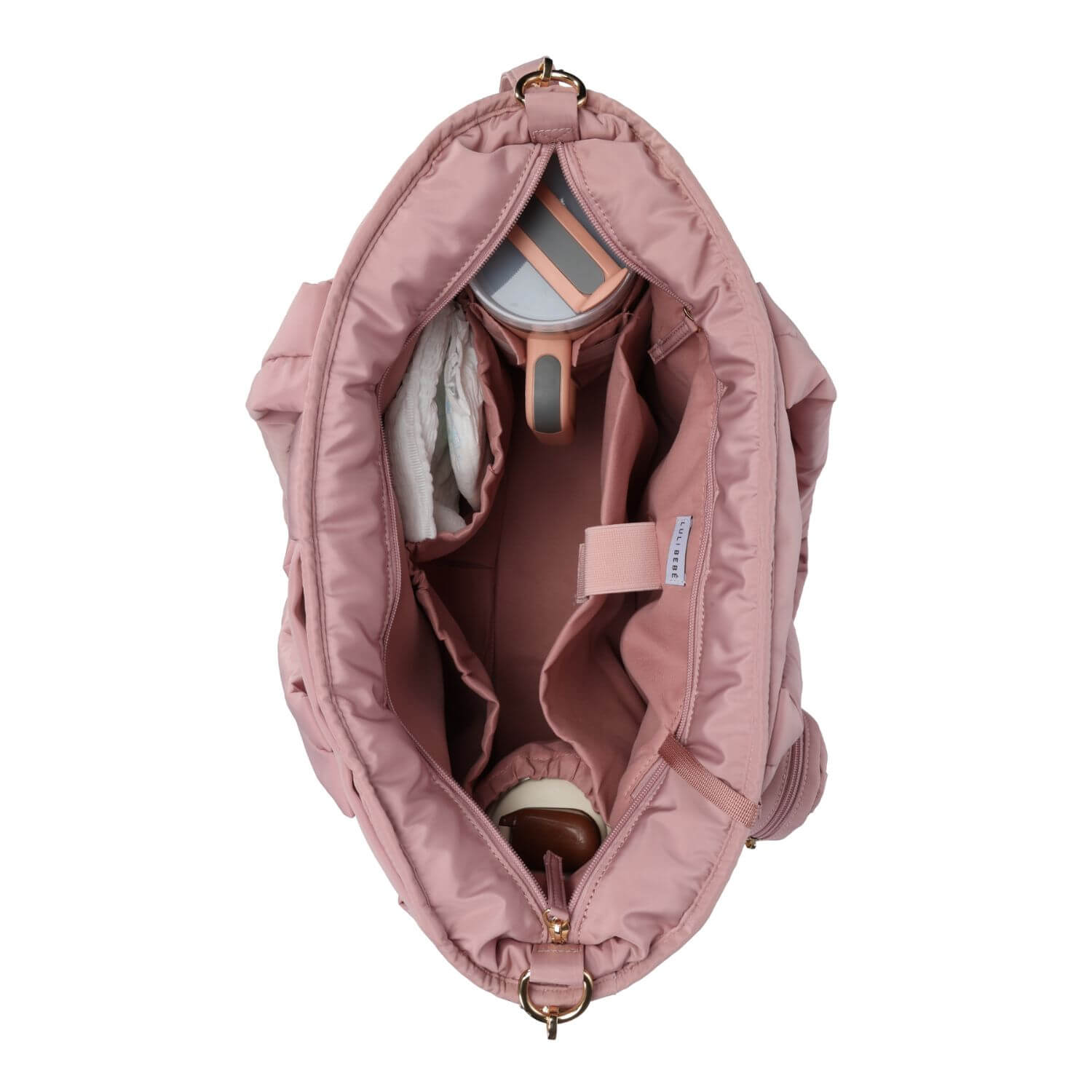 An overhead view of Luli Bebé Infinite Diaper Bag - Blush shown open to display its interior organization, including pockets, a cup holder, and storage compartments, on a solid white background.