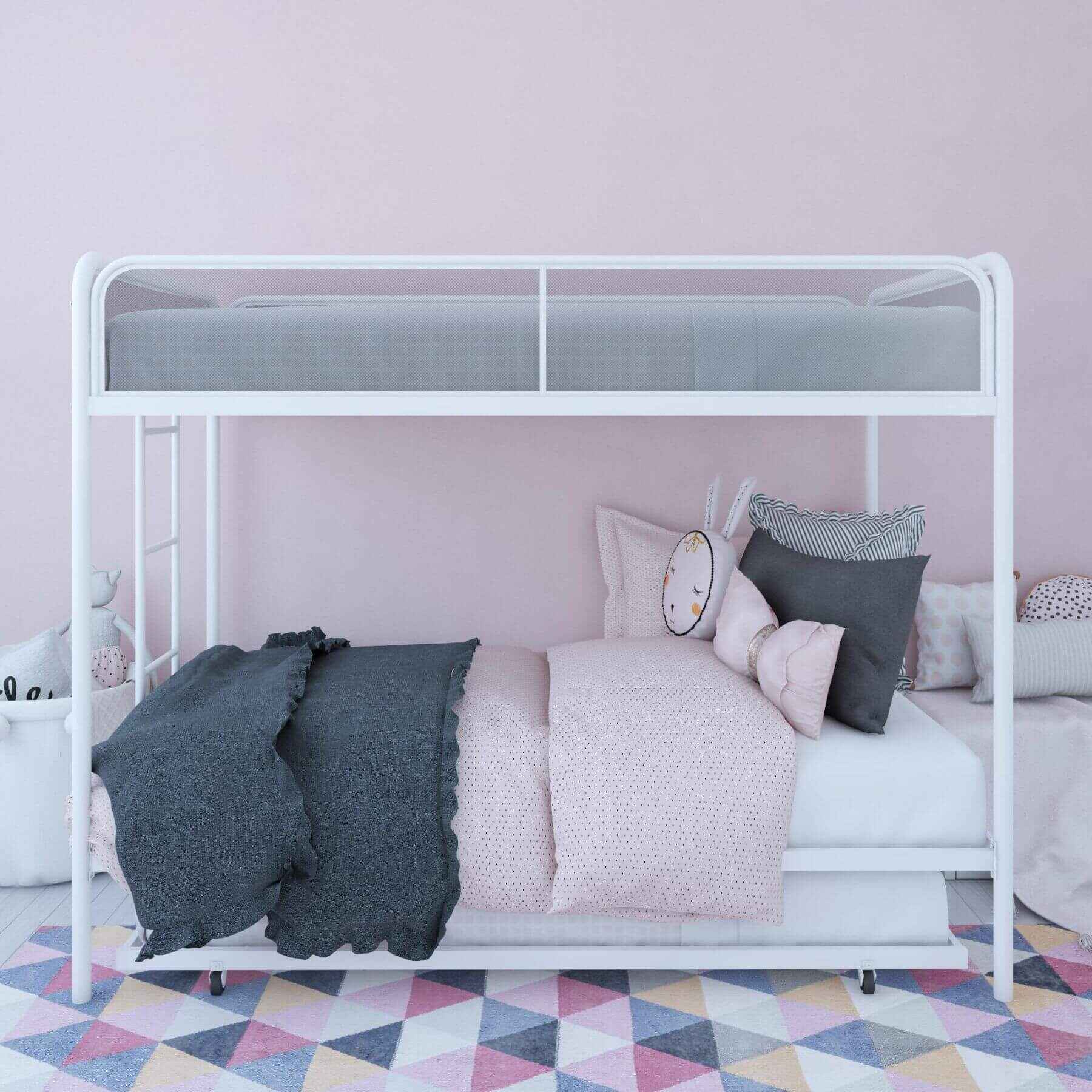 DHP Isaiah Triple Twin Metal Bunk Bed with pink bedding and gray pillows against a pink wall.
