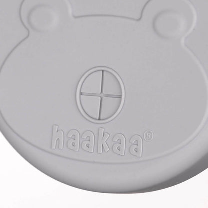 Gray silicone lid with 'haakaa' branding on a white background