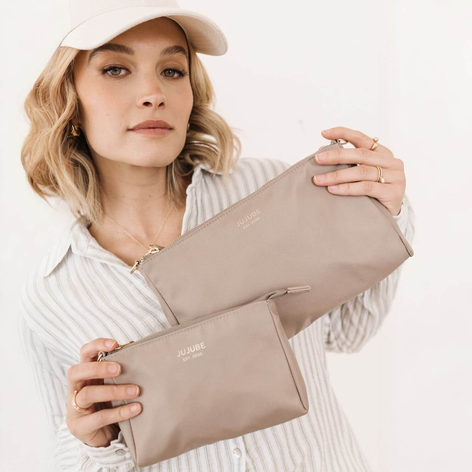 Woman Holding JuJuBe Pouch Clutch Purse Taupe