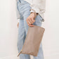 Woman Carrying JuJuBe Pouch Clutch Purse Taupe