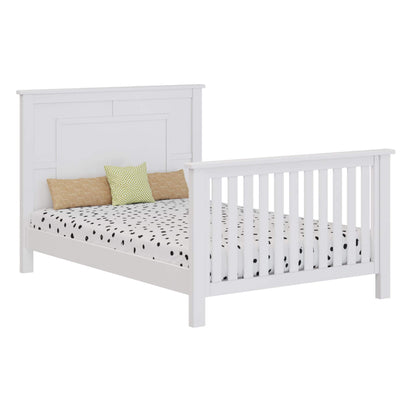 White bed with patterned bedding and colorful pillows on a white background