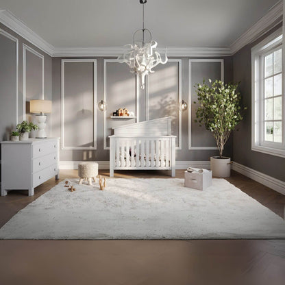 Modern nursery with "Just White"  Balanced Baby Convertible Crib, rug, and decor elements.