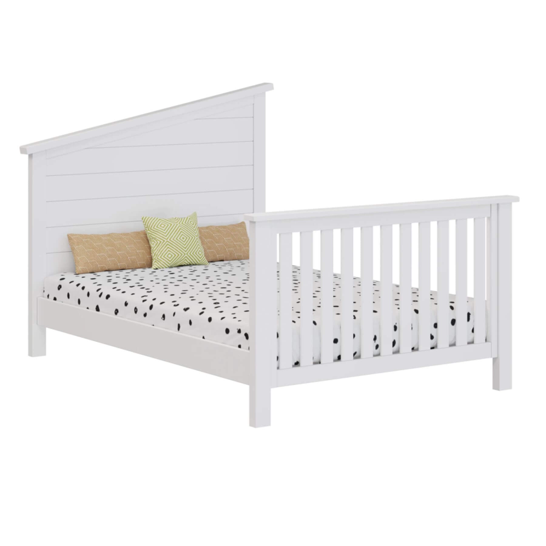 White wooden bed with polka dot bedding and colorful pillows
