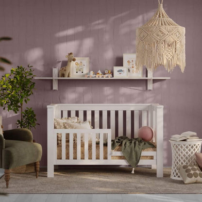 Nursery room with a white crib, shelves with decor, and a textured wall.