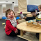 Kid Sitting at RAD Children's Furniture Kidney Table