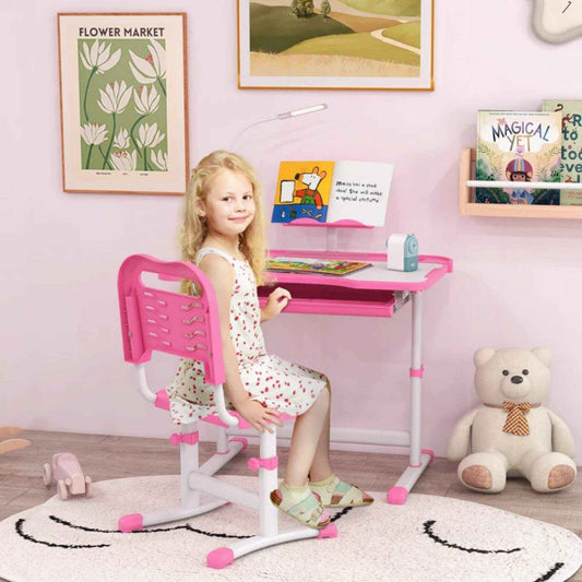 Girl Sitting at Qaba Kids Desk and Chair Set with USB Light, Storage Drawer, Pink