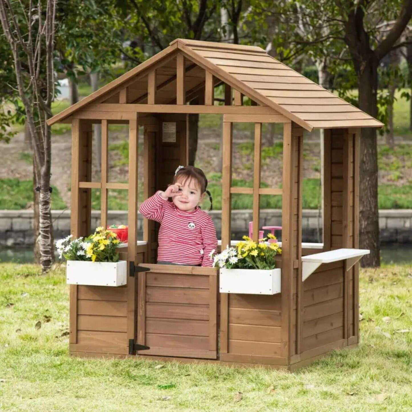 Girl Playing inside of Outsunny Kids Outdoor Wooden Playhouse Brown