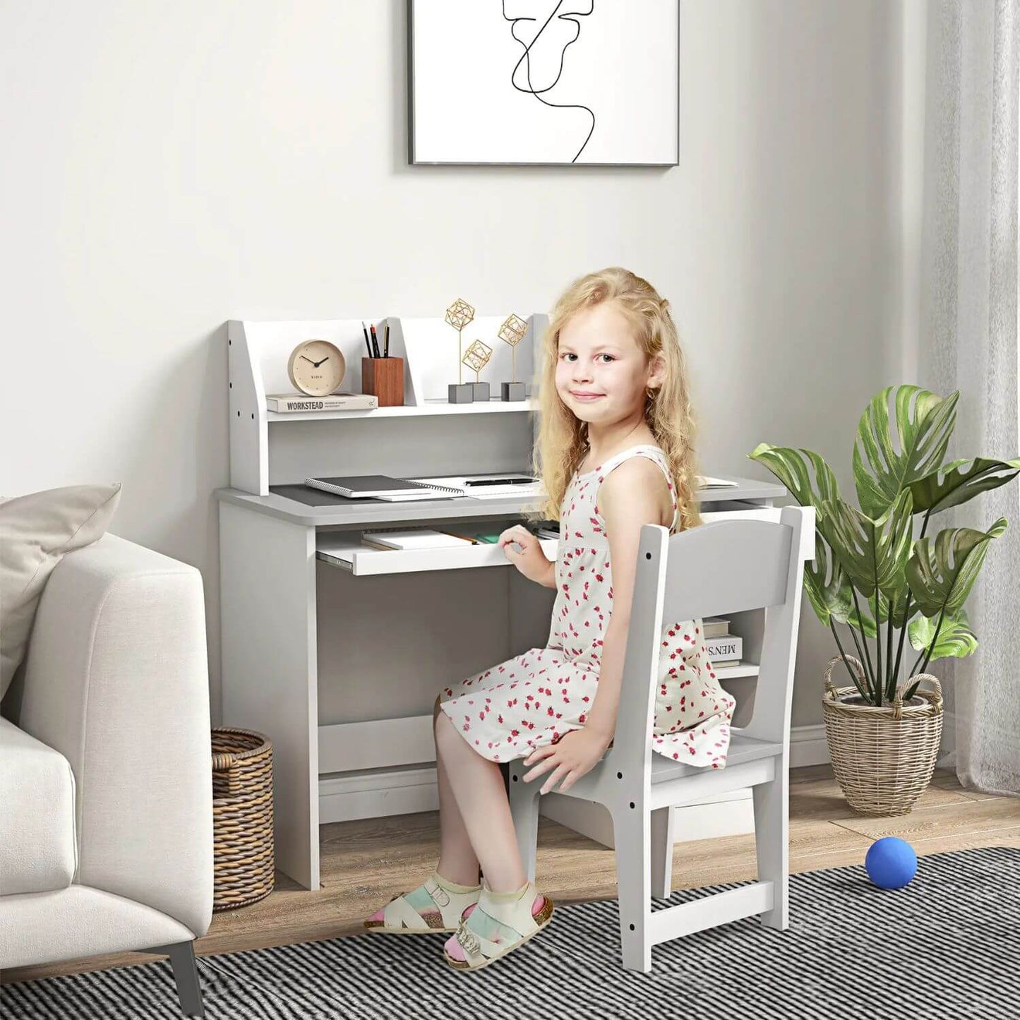 Girl Sitting at Qaba Kids Desk and Chair Set with Storage Gray