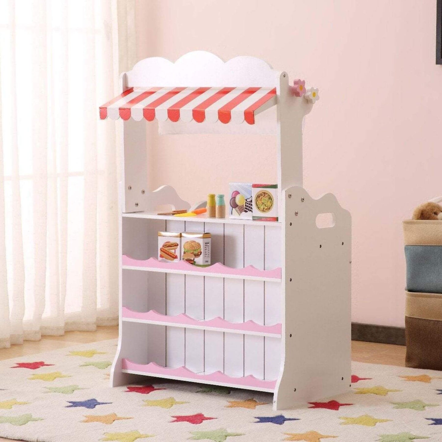 Kids Funnel 2 In 1 Pink Pretend Kitchen and Market Stall in a room with pink walls and colorful rug.