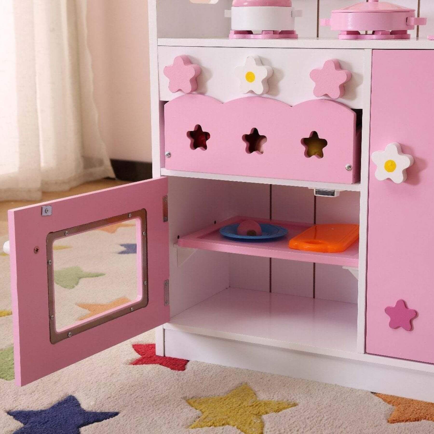 Kids Funnel 2 In 1 Pink Pretend Kitchen and Market Stall with open door in a room with star-patterned rug and curtains.
