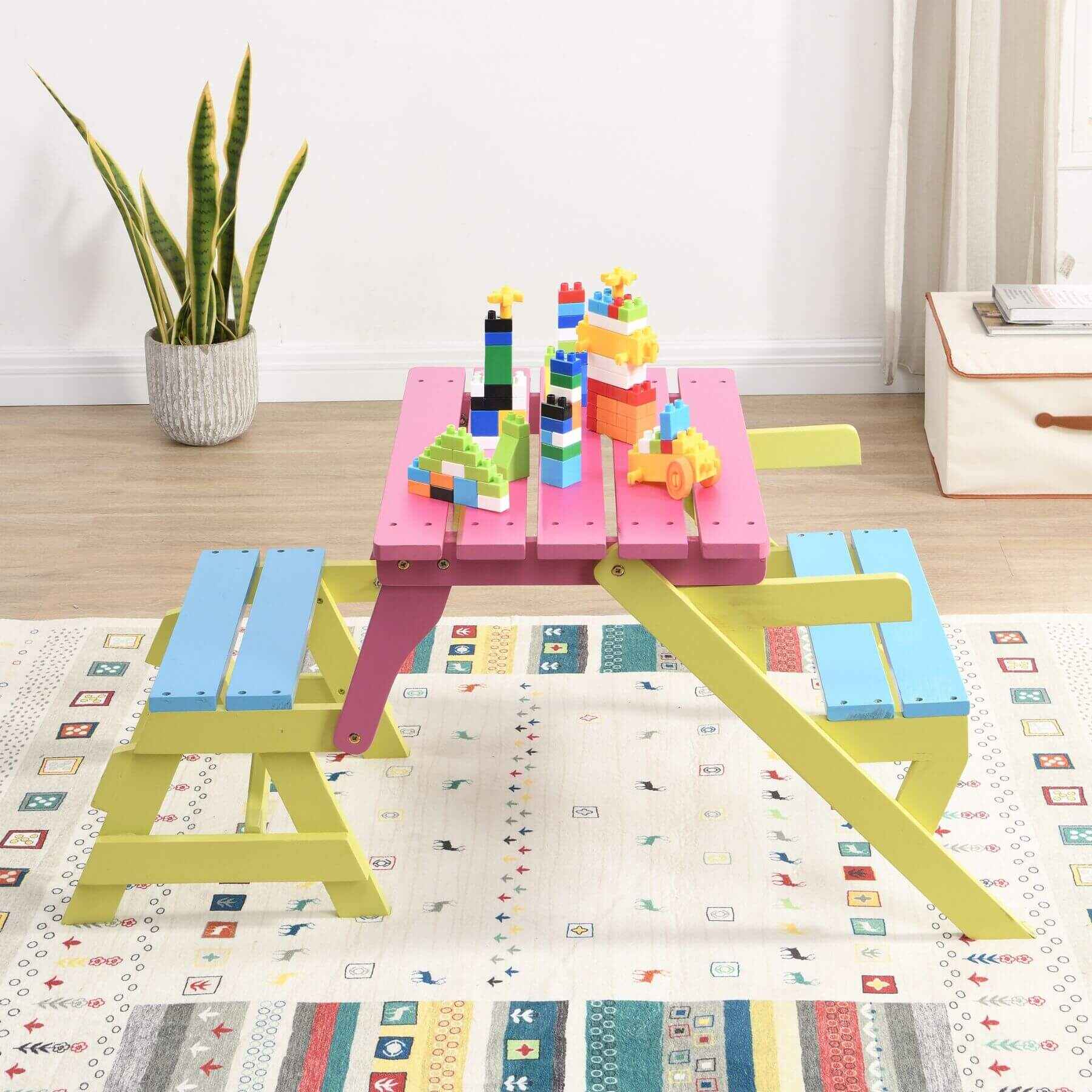 Colorful children's play table with building blocks on a patterned mat
