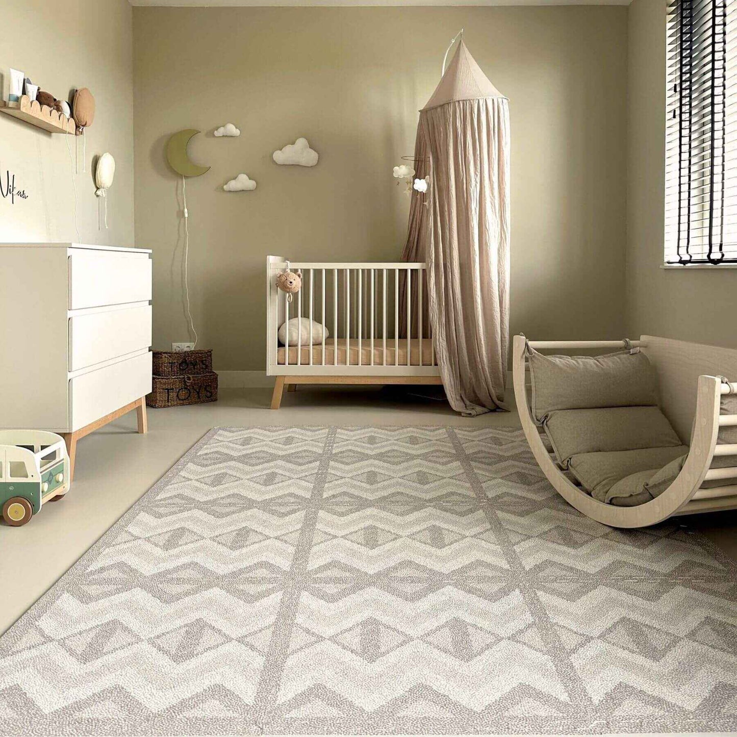 Nursery room with crib, rocking chair, and decorative elements on Eeveve Kilim Play Mat - Dark Taupe
