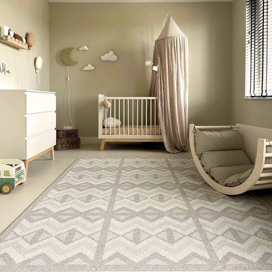 Nursery room with crib, rocking chair, and decorative elements on Eeveve Kilim Play Mat - Dark Taupe