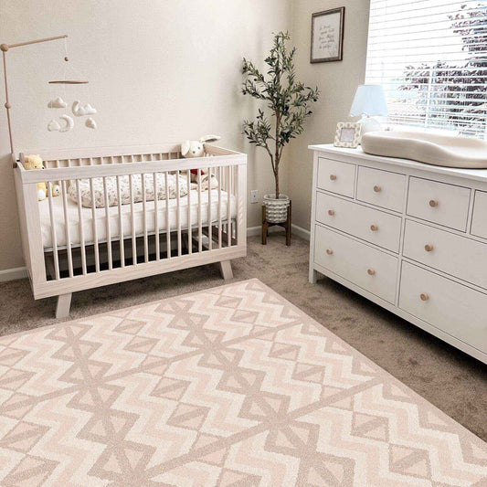 Nursery room with white crib, dresser, and Eeveve Kilim Play Mat - Soft Beige