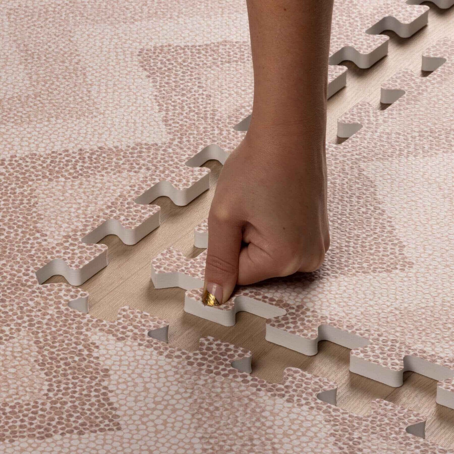 Hand placing on Eeveve Kilim Play Mat - Warm Pink